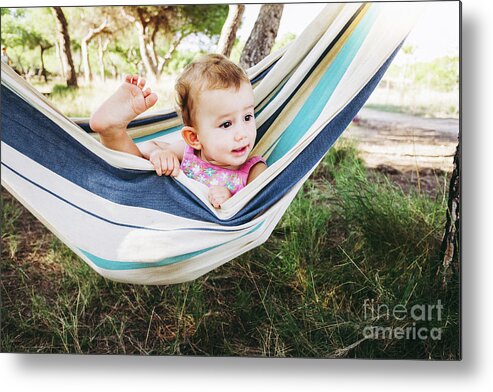 Adorable Metal Print featuring the photograph Adorable one year old girl inside a hammock smiling and having f by Joaquin Corbalan