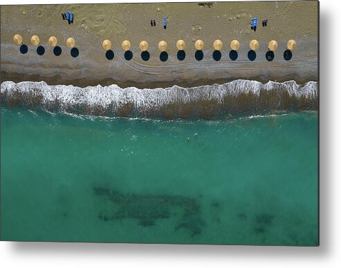  Beach Metal Print featuring the photograph Aerial view from a flying drone of beach umbrellas in a row on a by Michalakis Ppalis