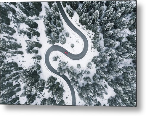 Scenics Metal Print featuring the photograph Aerial view of winding road in winter forest by © Marco Bottigelli