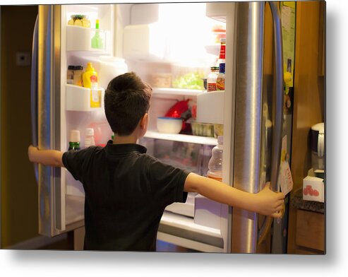Asian And Indian Ethnicities Metal Print featuring the photograph Asian boy searching through refrigerator by Jed Share/Kaoru Share