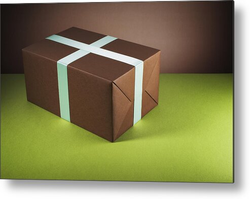 Wrapped Metal Print featuring the photograph Brown gift box by Microzoa Limited