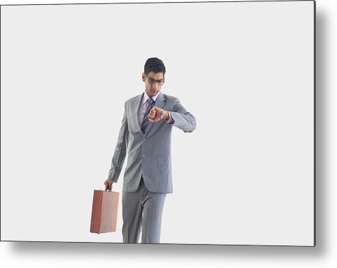 Young Men Metal Print featuring the photograph Businessman looking at watch by Abhinandita Mathur