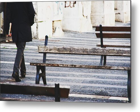 People Metal Print featuring the photograph Businessman walking outdoors between benches by Maurizio Siani