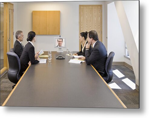 Corporate Business Metal Print featuring the photograph Businesspeople watching video conference in a conference room by Andersen Ross