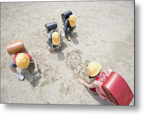 Education Metal Print featuring the photograph Children drawing in the sand by Image Source