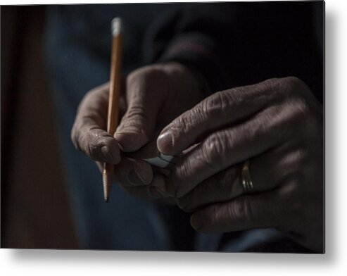 Working Metal Print featuring the photograph Close up of male hands holding a pencil and piece of wood by Raphye Alexius