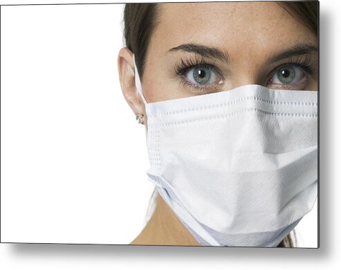 White Background Metal Print featuring the photograph Close Up Portrait Of A Young Adult Female Nurse In A Mask As She Looks At The Camera by Photodisc