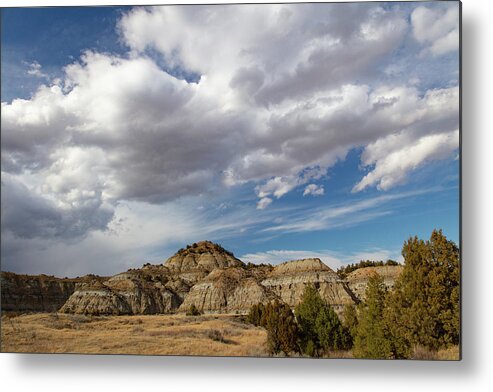 Buffalo Metal Print featuring the photograph Clouds over mountains at Theodore Roosevelt National Park in North Dakota by Eldon McGraw