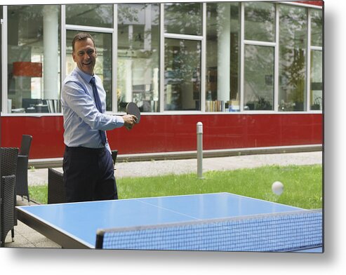 Corporate Business Metal Print featuring the photograph Confident happy businessman playing table tennis at creative office by Halfdark