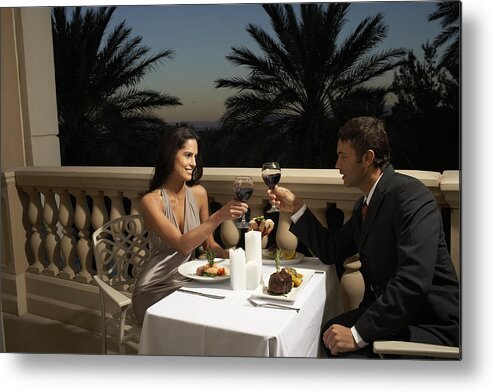 Heterosexual Couple Metal Print featuring the photograph Couple in evening wear having dinner on balcony, toasting with red wine by Andrea Chu