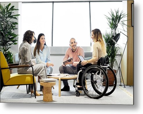 Young Men Metal Print featuring the photograph Disabled professional with coworkers in meeting by Morsa Images