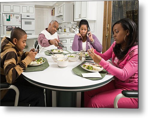 Two Generation Family Metal Print featuring the photograph Distracted family at the dinner table by Image Source