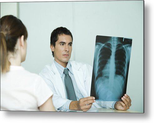 Headshot Metal Print featuring the photograph Doctor sitting across from female patient, holding x-ray by PhotoAlto/Ale Ventura
