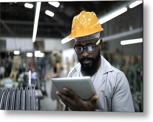 Working Metal Print featuring the photograph Engineer using tablet and working in factory by FG Trade