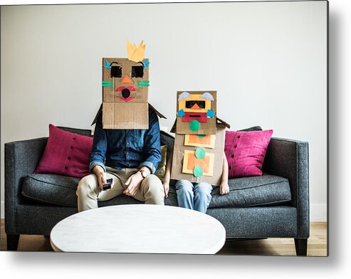 Atlanta Metal Print featuring the photograph Father and daughter wearing robot costumes watching television by MoMo Productions
