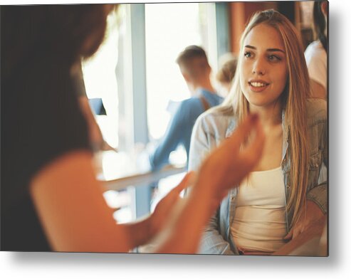 People Metal Print featuring the photograph Female young friends in cafe by Fotostorm
