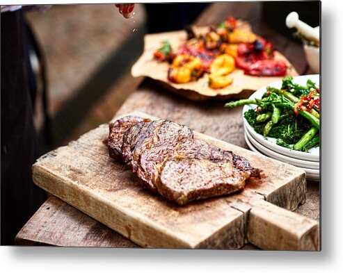 Sprinkling Metal Print featuring the photograph Freshly cooked steak on wooden board with salt flakes by 10'000 Hours