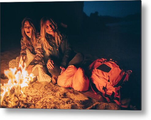 Hipster Metal Print featuring the photograph Friends enjoy evening on the beach by the log fire by AleksandarNakic
