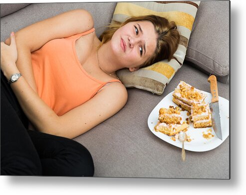 People Metal Print featuring the photograph Girl is having a stomach ache after eating many cake by JackF