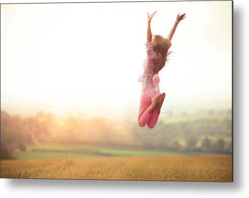 Human Arm Metal Print featuring the photograph Girl Jumping in Harvested Wheat Field by Olivia Bell Photography