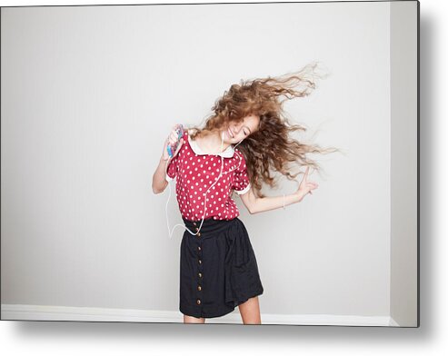 Three Quarter Length Metal Print featuring the photograph Girl wearing headphones, dancing and holding mp3 player by Davidgoldmanphoto