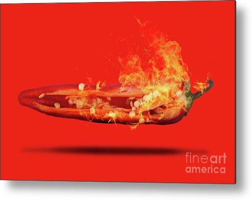 Red Metal Print featuring the photograph Half a red chili pepper on fire with seeds by Simon Bratt
