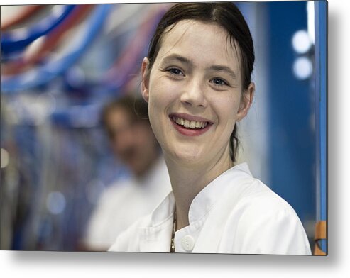 Working Metal Print featuring the photograph Head and shoulders of your woman wearing lab coat looking at camera smiling by Sigrid Gombert