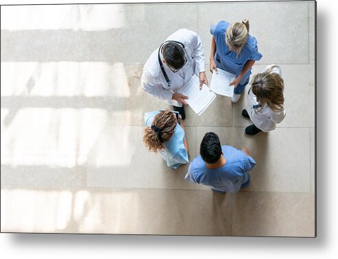 Working Metal Print featuring the photograph Healthcare professionals during a meeting at the hospital by Hispanolistic