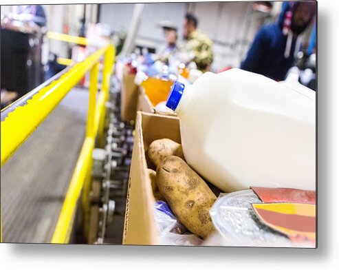 Working Metal Print featuring the photograph Healthy donated groceries in boxes at food bank warehouse by SDI Productions