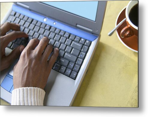 Shadow Metal Print featuring the photograph High angle view of young man operating a laptop by Colorblind Images LLC