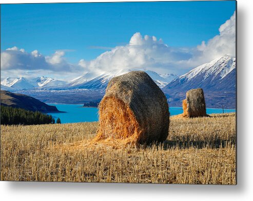 Tekapo Metal Print featuring the photograph Lake Tekapo with hay bales and mountain background by Lingxiao Xie