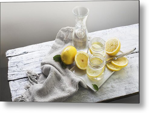 Vitamin C Metal Print featuring the photograph Lemon water on white wooden table. Still life. by Twomeows