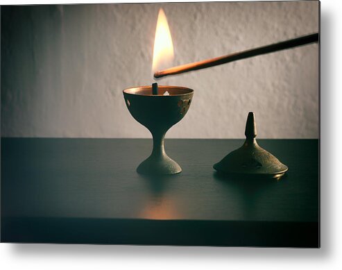 Tranquility Metal Print featuring the photograph Long match lighting an incense cone. by Harpazo_hope