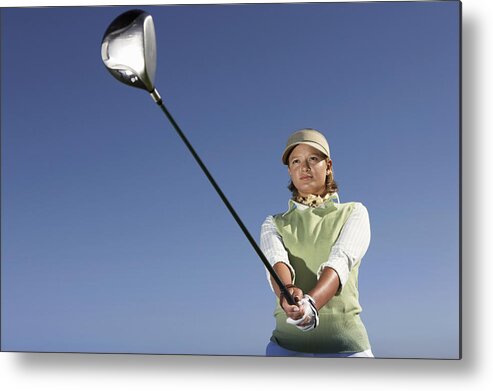 Sweater Metal Print featuring the photograph Low Angle View of a Woman Swinging a Golf Club by John Cumming