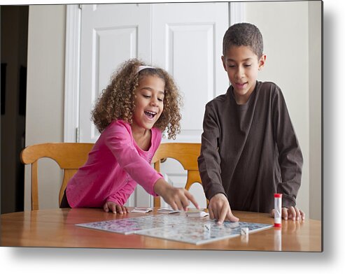 4-5 Years Metal Print featuring the photograph Mixed race children playing board game together by Jeff Greenough