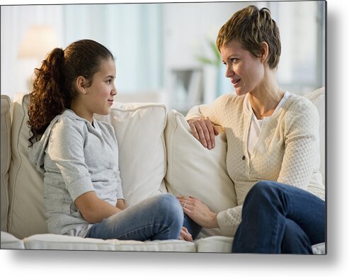 Three Quarter Length Metal Print featuring the photograph Mother and daughter having a serious talk by Tetra Images