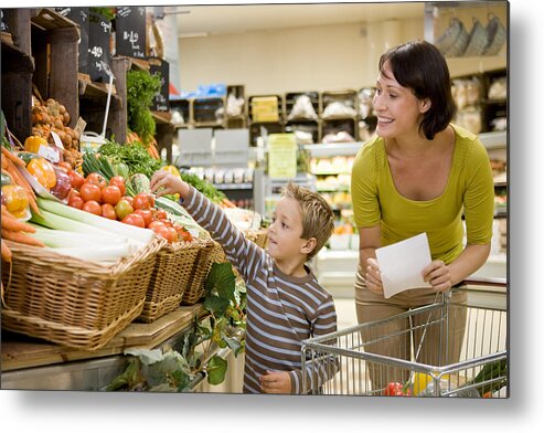 Mid Adult Women Metal Print featuring the photograph Mother and son in supermarket by Image Source