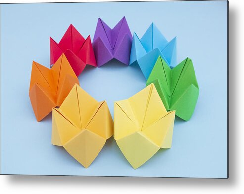 Dublin Metal Print featuring the photograph Paper Fortune Tellers arranged by colour on a blue background by Catherine MacBride