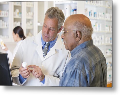 Expertise Metal Print featuring the photograph Pharmacist talking to customer about prescription by Ariel Skelley