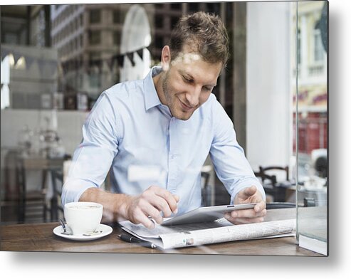 People Metal Print featuring the photograph Portrait of mid adult man using digital tablet at cafe by Tomas Rodriguez