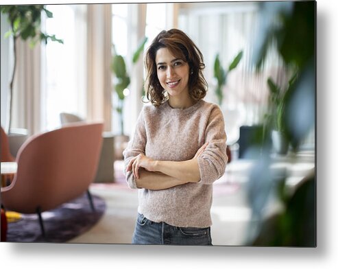 New Business Metal Print featuring the photograph Portrait of smiling female entrepreneur standing at workplace by Maskot