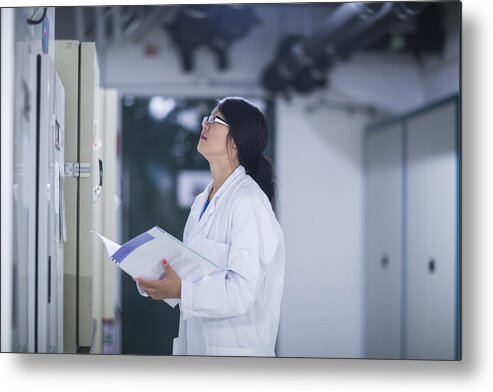 Working Metal Print featuring the photograph Scientist in control room by Sigrid Gombert