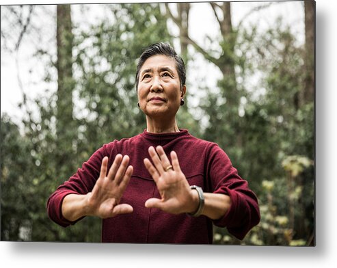 Atlanta Metal Print featuring the photograph Senior woman doing Tai Chi outdoors by MoMo Productions