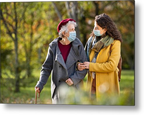 Cold And Flu Metal Print featuring the photograph Senior woman with lovely girl wearing face mask at park by Ridofranz