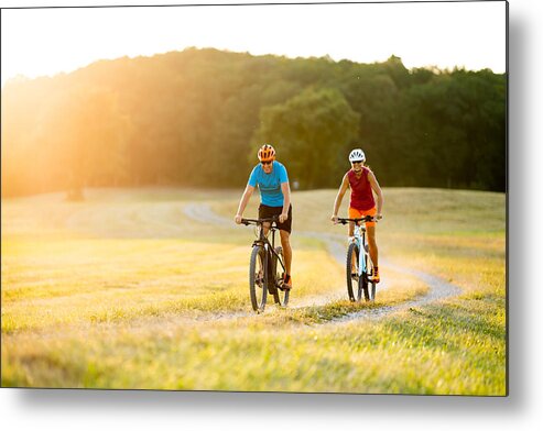 Electric Bicycle Metal Print featuring the photograph Smiling Sporty Couple On Mountain Bikes In Rural Landscape by Amriphoto