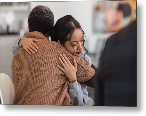 Problems Metal Print featuring the photograph Supportive women hug while attending a group therapy session by FatCamera