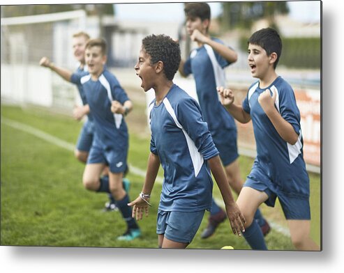 Soccer Uniform Metal Print featuring the photograph Team of Confident Young Male Footballers Running Onto Field by Xavierarnau