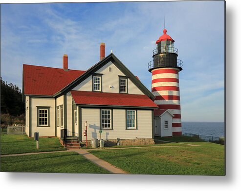 Tranquility Metal Print featuring the photograph The red-and-white striped West Quoddy Head Lighthouse in Maine by Rainer Grosskopf