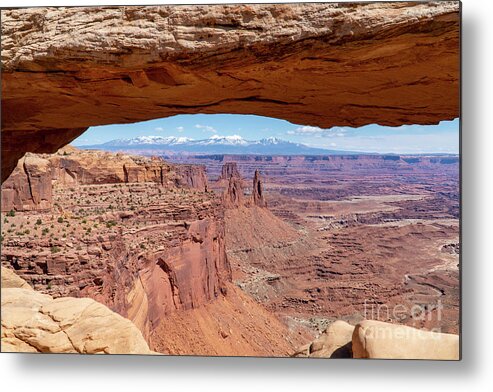 Canyonlands National Park Metal Print featuring the photograph The Washerwoman Arch is framed by the Mesa Arch at Canyonlands N by William Kuta