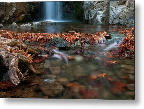 Troodos Metal Print featuring the photograph Waterfall and river flowing with maple leaves on the rocks on the river in Autumn by Michalakis Ppalis